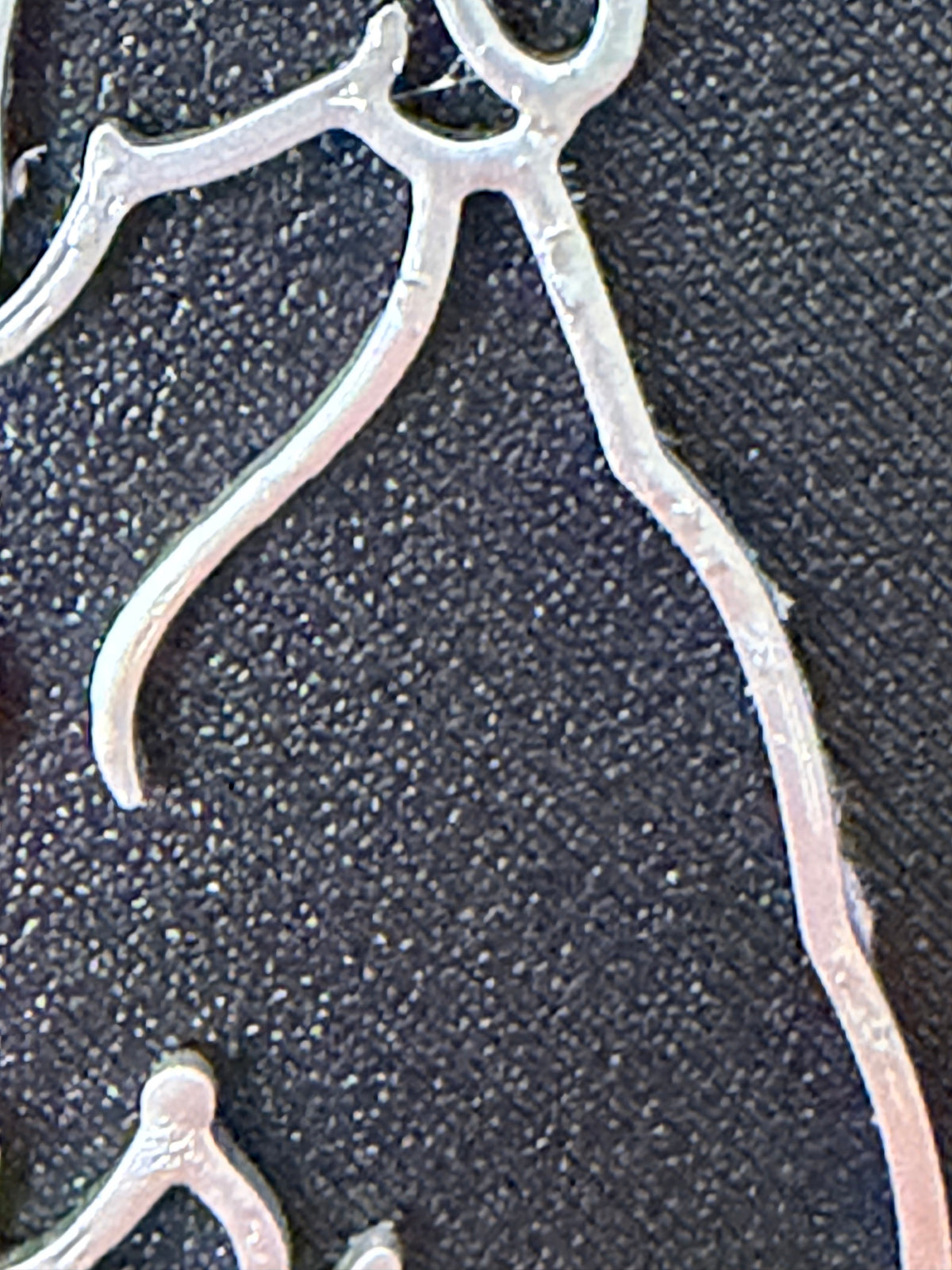 Echte detailfoto · zilver op zwart